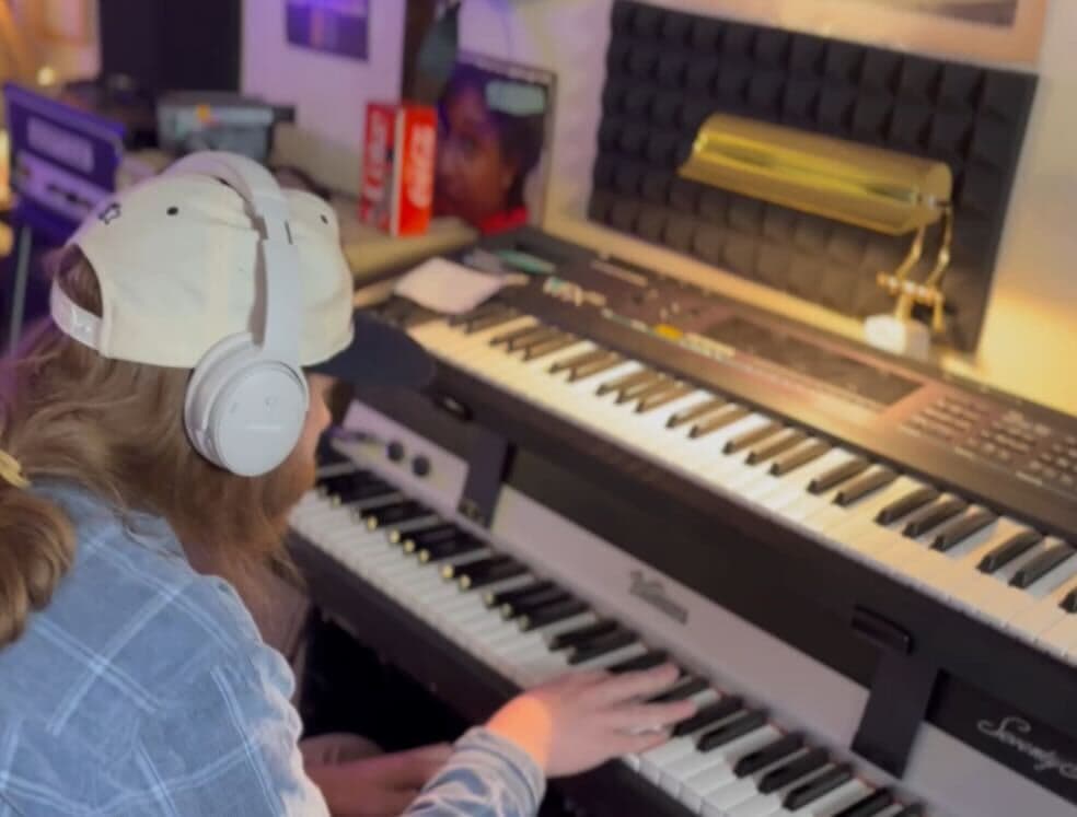 Keyboardist playing stacked keyboards during a Monorail Sound session