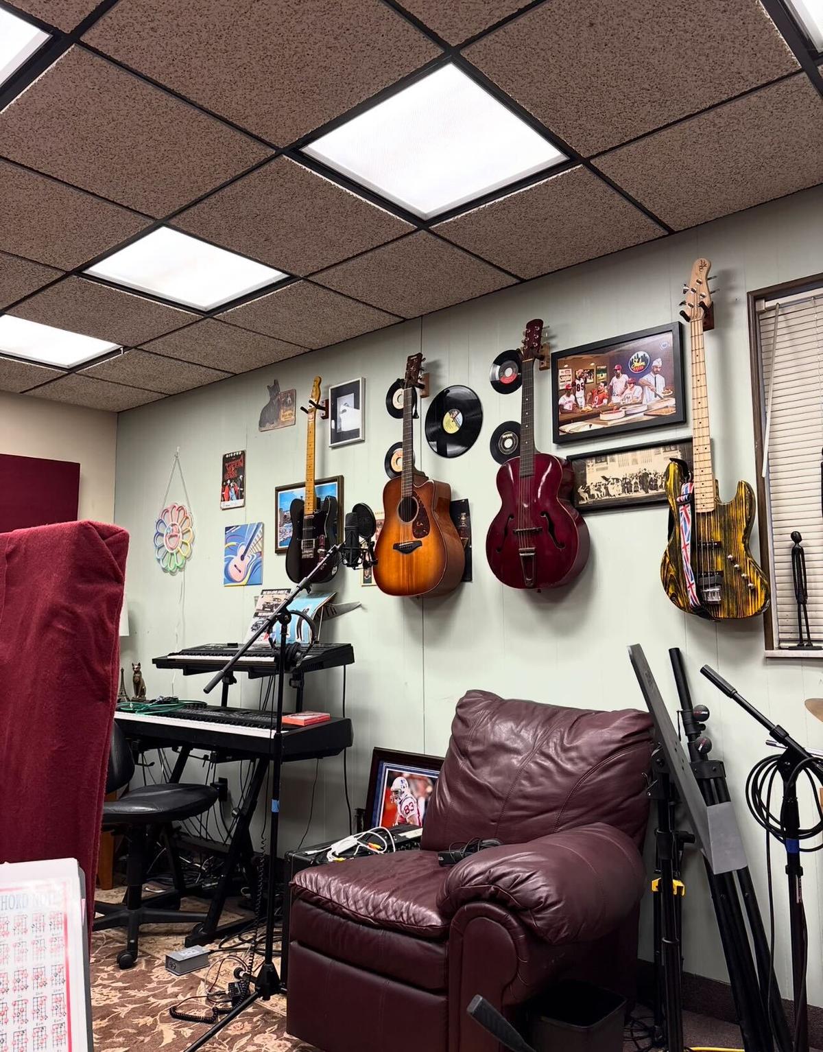 Guitar wall and lounge seating inside Monorail Sound recording studio