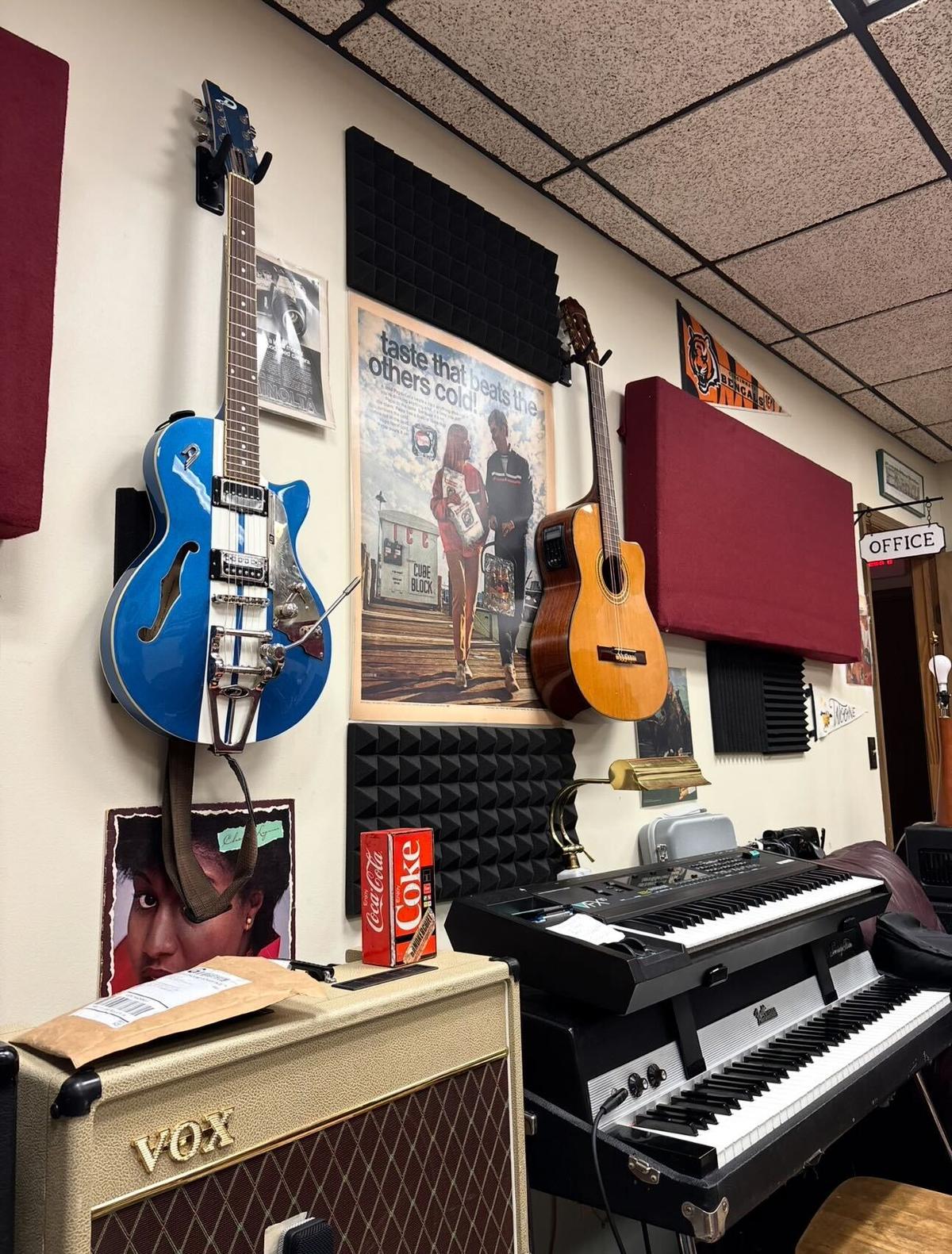 Guitar wall, keyboards, and amps inside the Monorail Sound studio