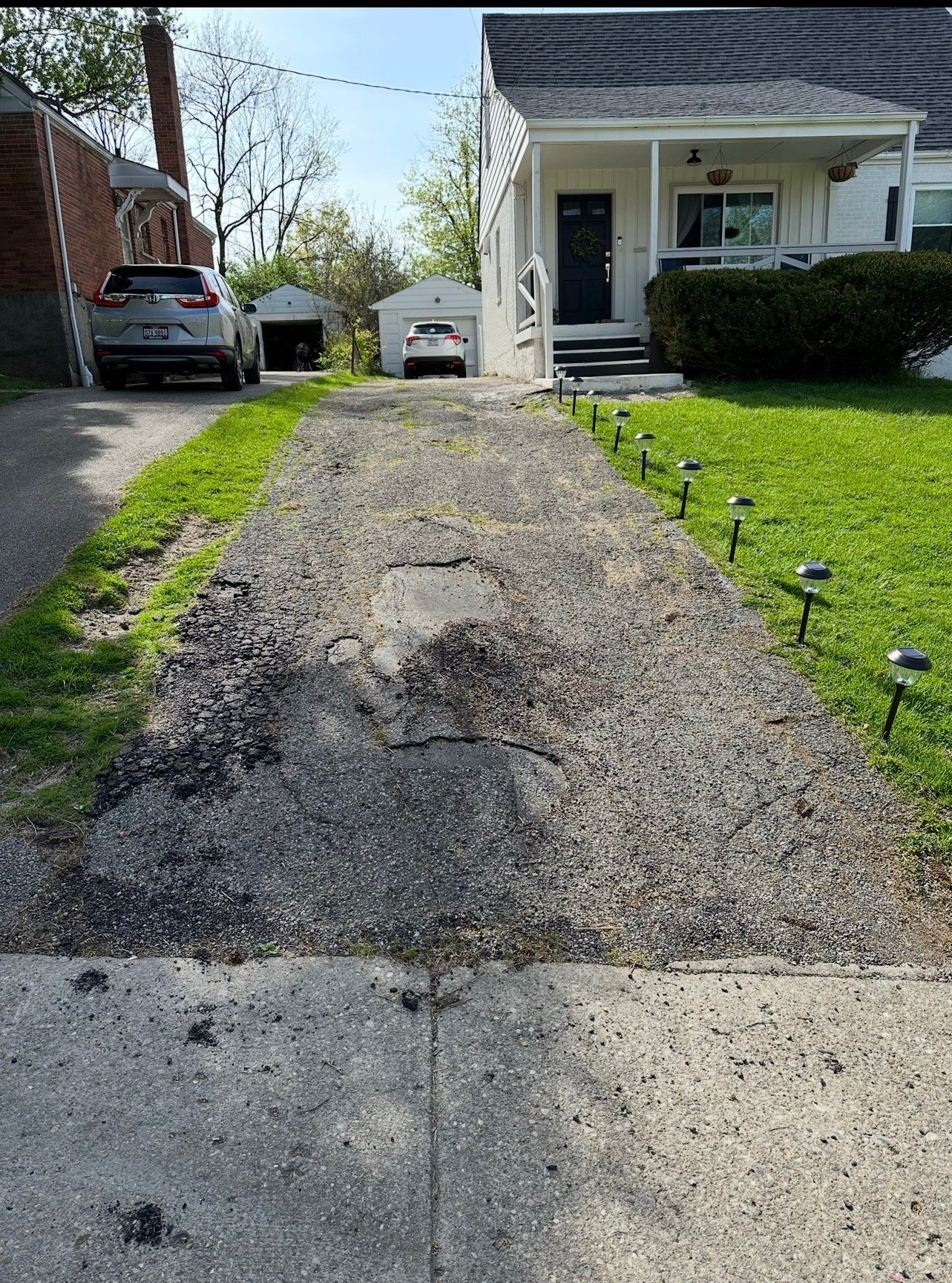 Cracked and settled concrete driveway in Warren County, Ohio before replacement