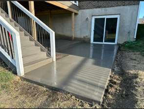 Bare dirt under a raised deck in Lebanon, Ohio before concrete patio pour