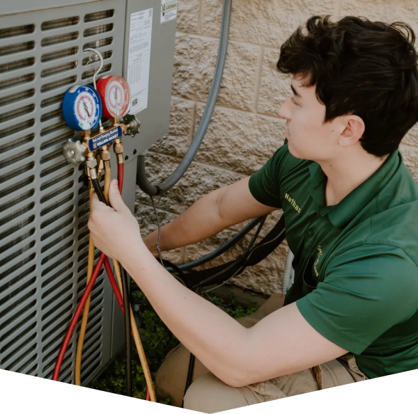 Sycamore Heating & Cooling technician working on an outdoor AC condenser during an installation