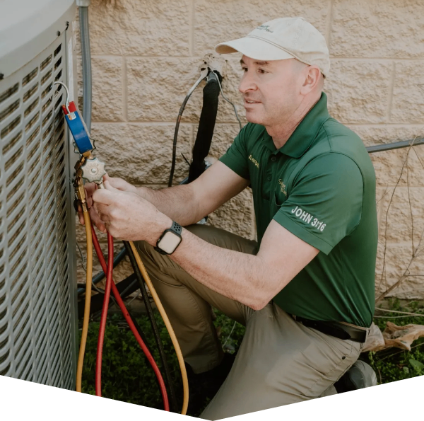Sycamore Heating & Cooling technician inspecting a furnace and HVAC equipment