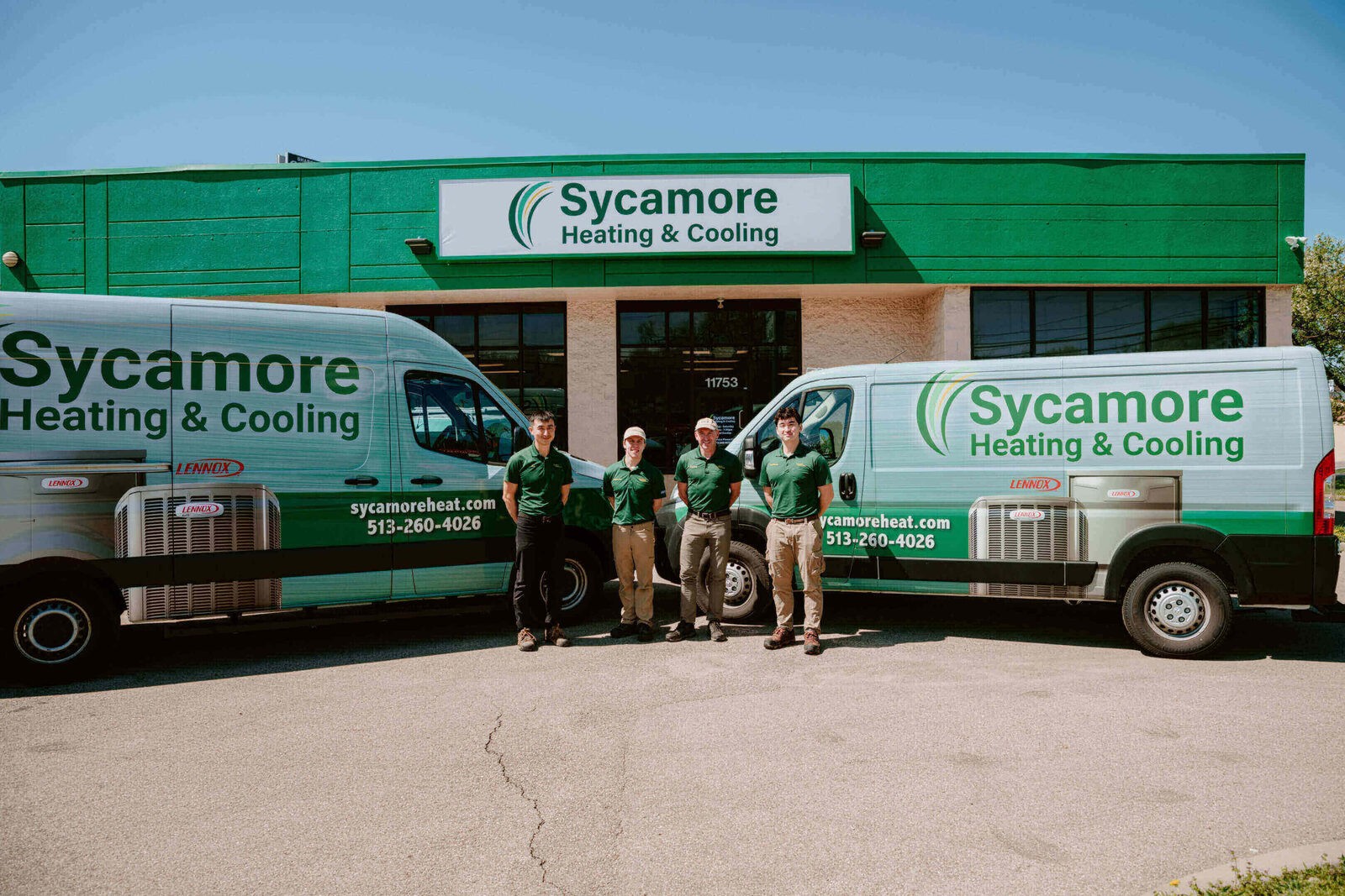 Sycamore Heating & Cooling owner and team with service vans at the Cincinnati shop
