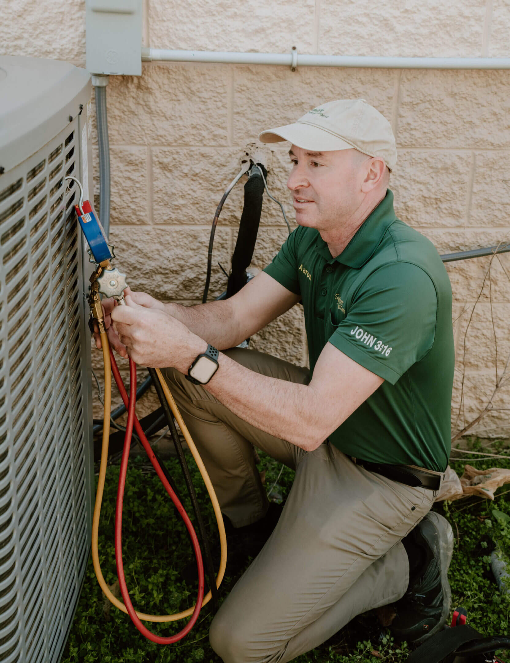 Sycamore Heating & Cooling technician servicing an outdoor AC condenser unit