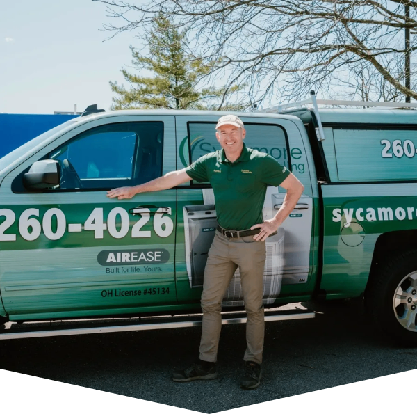 Sycamore Heating & Cooling technician next to a service van, ready for maintenance visit