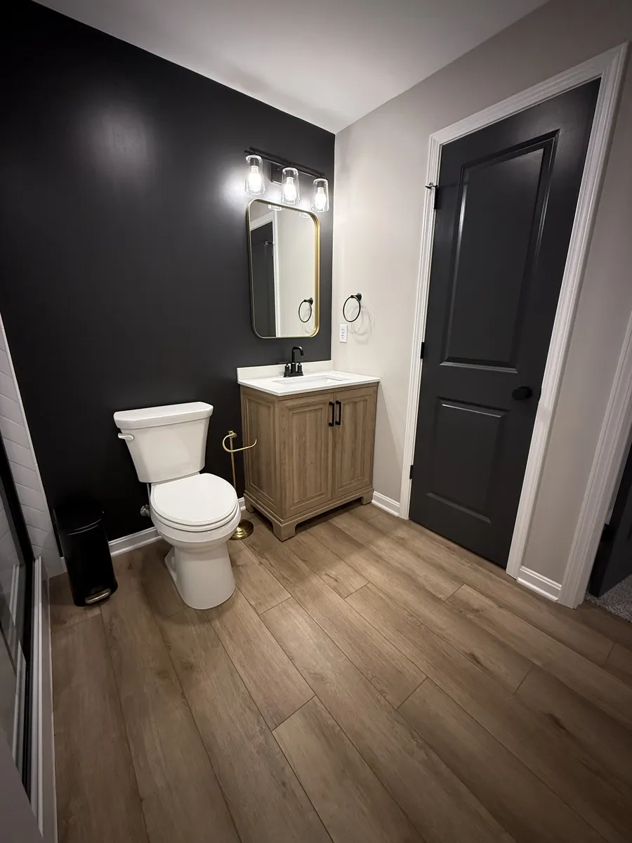 Black Walled Basement Powder Room